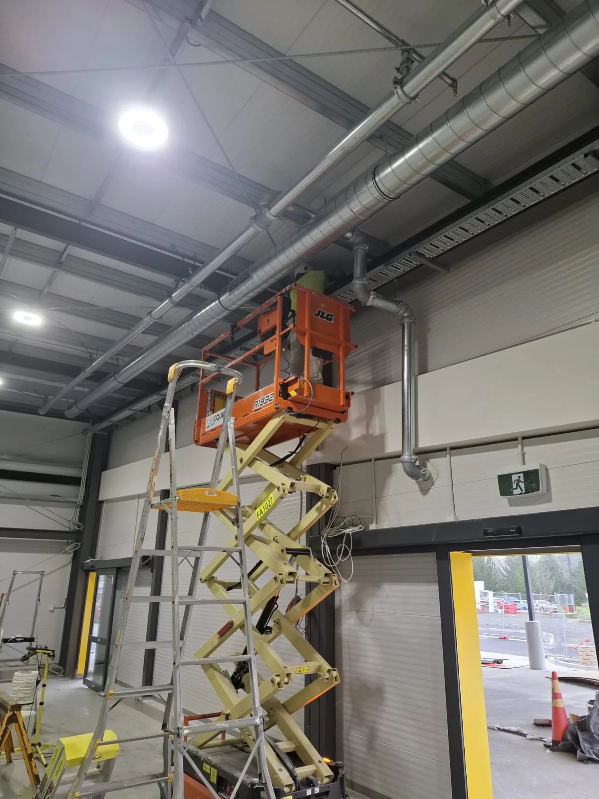 Commercial interior painting underway at height