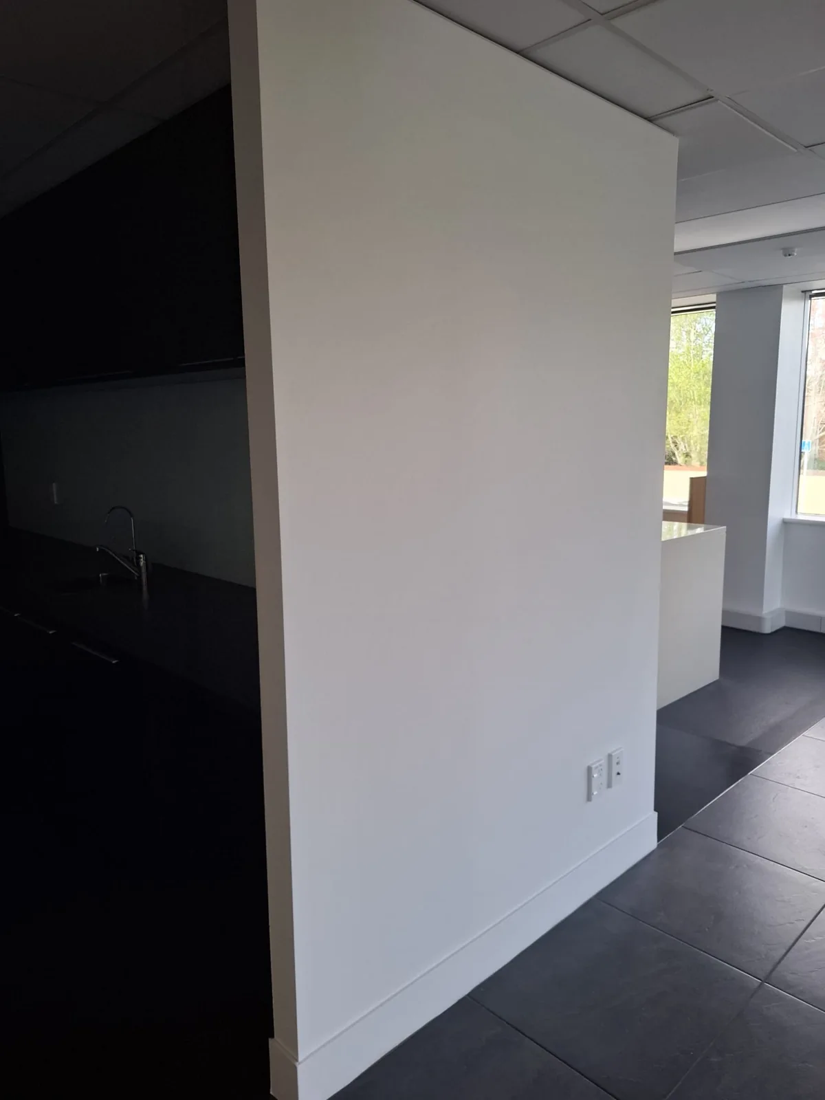 Crisp white interior walls and dark feature area