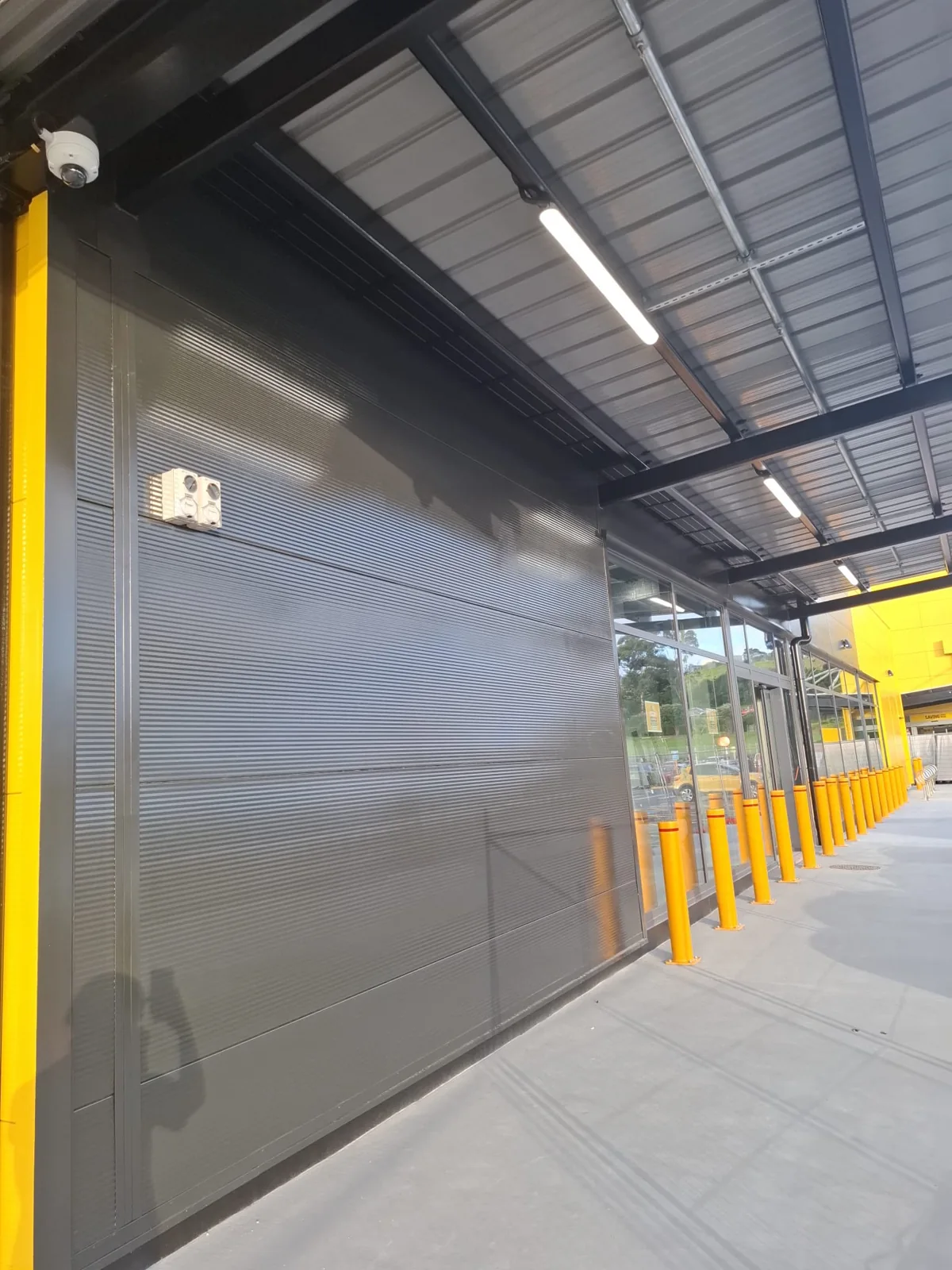 Commercial feature wall finished in dark grey with yellow accents
